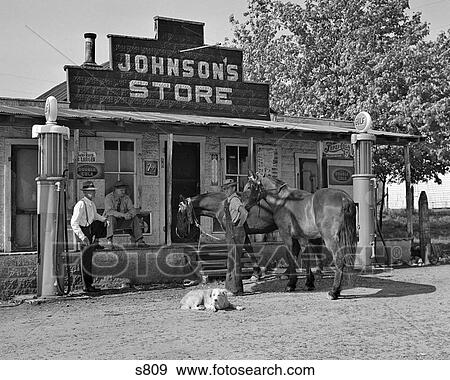 1930S Group Of Three Men Two Horses And A Dog Looking At Camera Gathered In Front Of Country Store Bracketed By Old Gas Pumps View Large Photo Image Stock Photo - 1930S Group Of Three Men Two Horses And A Dog Looking At Camera Gathered In Front Of Country Store Bracketed By Old Gas Pumps. Fotosearch