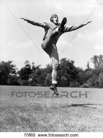 1930S High School Or College Football Player Punting The Ball View Large Photo Image Stock Photography - 1930S High School Or College Football Player Punting The Ball. Fotosearch