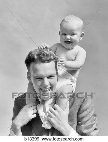1930s LAUGHING FATHER CARRYING BABY SON ON HIS SHOULDERS AS KID PULLS DAD'S HAIR View Large Photo Image Stock Photo - 1930s LAUGHING FATHER CARRYING BABY SON ON HIS SHOULDERS AS KID PULLS DAD'S HAIR. Fotosearch