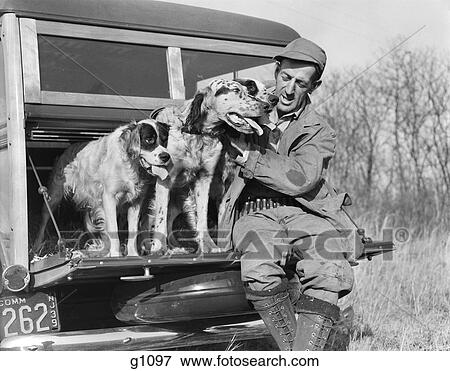 1930S Man In Hunting Clothing Sitting On Tailgate Of Woodie Station Wagon With English Setter Dogs View Large Photo Image Stock Photo - 1930S Man In Hunting Clothing Sitting On Tailgate Of Woodie Station Wagon With English Setter Dogs. Fotosearch