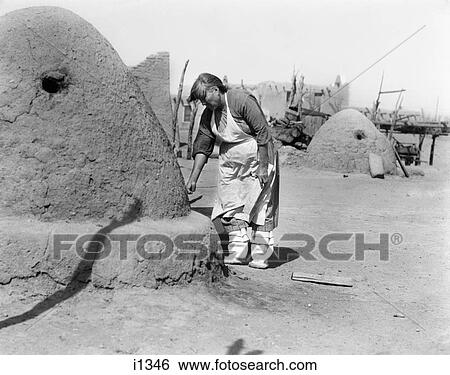 1930s NATIVE AMERICAN INDIAN WOMAN BAKING BREAD IN OUTDOOR HORNO OVEN SANTA CLARA PUEBLO NEW MEXICO USA View Large Photo Image Stock Photograph - 1930s NATIVE AMERICAN INDIAN WOMAN BAKING BREAD IN OUTDOOR HORNO OVEN SANTA CLARA PUEBLO NEW MEXICO USA. Fotosearch