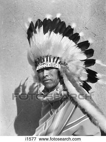 1930S Native American Man Wearing Full Feathered Headdress War Bonnet Looking At Camera San Ildefonso Pueblo New Mexico Usa View Large Photo Image Stock Photo - 1930S Native American Man Wearing Full Feathered Headdress War Bonnet Looking At Camera San Ildefonso Pueblo New Mexico Usa. Fotosearch