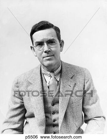 Stock Photograph - 1930S Portrait Man Photographer H. Armstrong Roberts Wearing Glasses Suit Vest Tie Looking At Camera. Fotosearch