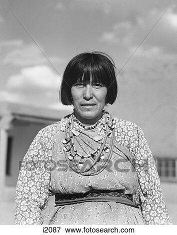 Stock Photo - 1930S Portrait Native American Woman Looking At Camera Wearing Typical Costume And Jewelry San Ildefonso Pueblo New Mexico . Fotosearch
