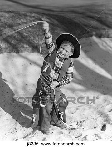 1930S Smiling Boy In Cowboy Outfit Swinging Lasso Looking At Camera View Large Photo Image Stock Photograph - 1930S Smiling Boy In Cowboy Outfit Swinging Lasso Looking At Camera. Fotosearch