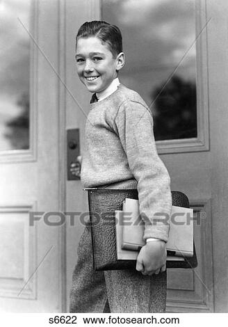 1930S Smiling Boy Student Carrying Textbooks Standing By School Door Entrance Looking At Camera View Large Photo Image Stock Image - 1930S Smiling Boy Student Carrying Textbooks Standing By School Door Entrance Looking At Camera. Fotosearch