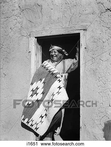 1930s SMILING NATIVE AMERICAN INDIAN MAN STANDING IN DOORWAY WEARING TYPICAL COSTUME SAN ILDEFONSO PUEBLO NEW MEXICO USA View Large Photo Image Stock Image - 1930s SMILING NATIVE AMERICAN INDIAN MAN STANDING IN DOORWAY WEARING TYPICAL COSTUME SAN ILDEFONSO PUEBLO NEW MEXICO USA. Fotosearch