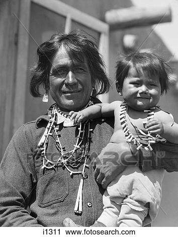 1930S Smiling Native American Man Looking At Camera Holding His Son Cochiti Pueblo New Mexico Usa View Large Photo Image Stock Image - 1930S Smiling Native American Man Looking At Camera Holding His Son Cochiti Pueblo New Mexico Usa. Fotosearch
