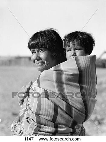 1930S Smiling Native American Mother Looking At Camera Carrying Baby On Her Back Cochiti Pueblo New Mexico Usa View Large Photo Image Stock Image - 1930S Smiling Native American Mother Looking At Camera Carrying Baby On Her Back Cochiti Pueblo New Mexico Usa . Fotosearch