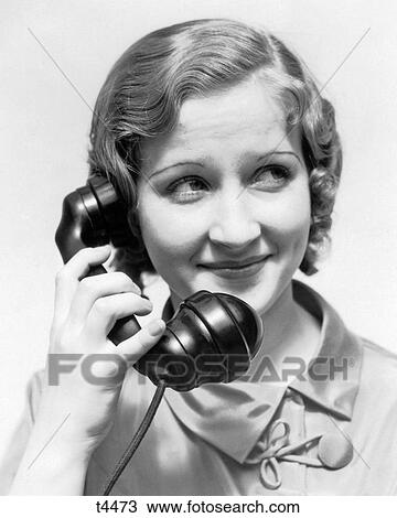 1930s SMILING WOMAN TALKING ON TELEPHONE View Large Photo Image Stock Image - 1930s SMILING WOMAN TALKING ON TELEPHONE. Fotosearch