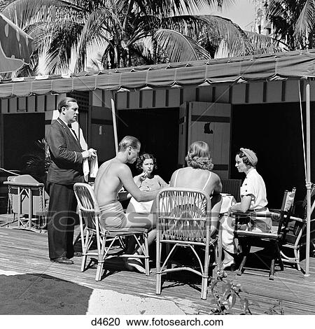 1930s THREE WOMEN ONE MAN DINING BY BEACH WAITER TAKING ORDER NAUTILUS HOTEL CABANA CLUB MIAMI BEACH FLORIDA USA View Large Photo Image Stock Image - 1930s THREE WOMEN ONE MAN DINING BY BEACH WAITER TAKING ORDER NAUTILUS HOTEL CABANA CLUB MIAMI BEACH FLORIDA USA. Fotosearch