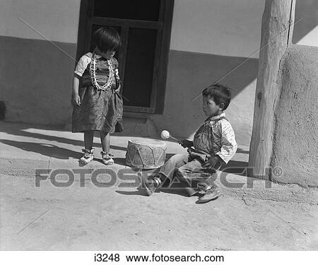 1930S Two Native American Children Boy And Girl Playing With Drum San Ildefonso Pueblo New Mexico Usa View Large Photo Image Stock Photo - 1930S Two Native American Children Boy And Girl Playing With Drum San Ildefonso Pueblo New Mexico Usa. Fotosearch