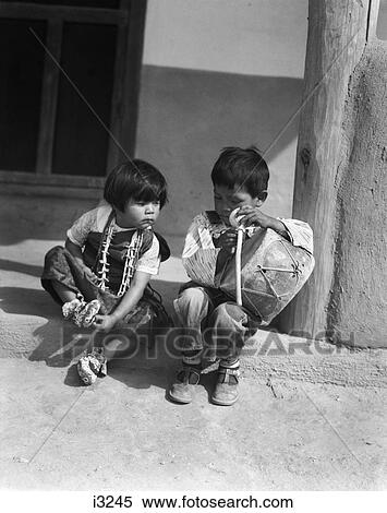 1930S Two Native American Children Boy And Girl Playing With Drum San Ildefonso Pueblo New Mexico Usa View Large Photo Image Stock Photography - 1930S Two Native American Children Boy And Girl Playing With Drum San Ildefonso Pueblo New Mexico Usa. Fotosearch