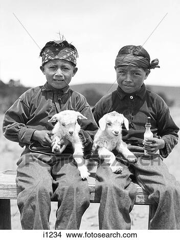 1930S Two Native American Navajo Boys Looking At Camera Holding Two Baby Lambs New Mexico Usa View Large Photo Image Picture - 1930S Two Native American Navajo Boys Looking At Camera Holding Two Baby Lambs New Mexico Usa. Fotosearch