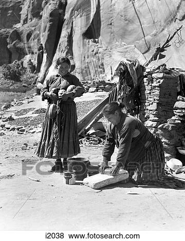 1930s TWO NATIVE AMERICAN NAVAJO INDIAN WOMEN GRINDING CORN AND HARVESTING SQUASH CANYON DEL MUERTO ARIZONA USA View Large Photo Image Stock Photo - 1930s TWO NATIVE AMERICAN NAVAJO INDIAN WOMEN GRINDING CORN AND HARVESTING SQUASH CANYON DEL MUERTO ARIZONA USA. Fotosearch