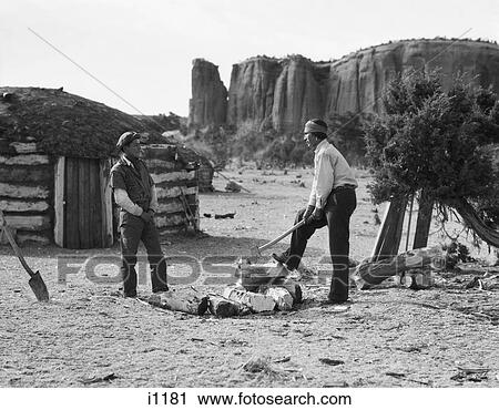 1930S Two Native American Navajo Men Splitting Fire Wood With Ax Traditional Hogan Home Is In The Background View Large Photo Image Stock Image - 1930S Two Native American Navajo Men Splitting Fire Wood With Ax Traditional Hogan Home Is In The Background . Fotosearch