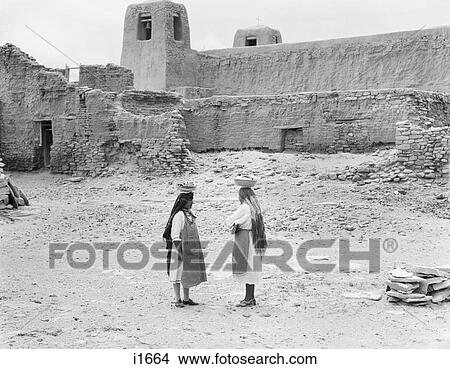 1930S Two Native American Women In Sky City The Oldest Continuously Inhabited City In North America Acoma Pueblo New Mexico Usa View Large Photo Image Picture - 1930S Two Native American Women In Sky City The Oldest Continuously Inhabited City In North America Acoma Pueblo New Mexico Usa. Fotosearch