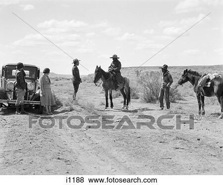 1930s TWO NAVAJO MEN WITH PONIES STOP TO SPEAK TO PARK RANGER WITH TWO WOMEN TOURISTS View Large Photo Image Stock Photo - 1930s TWO NAVAJO MEN WITH PONIES STOP TO SPEAK TO PARK RANGER WITH TWO WOMEN TOURISTS. Fotosearch