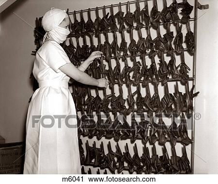 1930s WOMAN NURSE IN SURGICAL GOWN & MASK ADJUSTING RACK OF STERILIZED RECYCLED RUBBER GLOVES View Large Photo Image Stock Image - 1930s WOMAN NURSE IN SURGICAL GOWN & MASK ADJUSTING RACK OF STERILIZED RECYCLED RUBBER GLOVES. Fotosearch