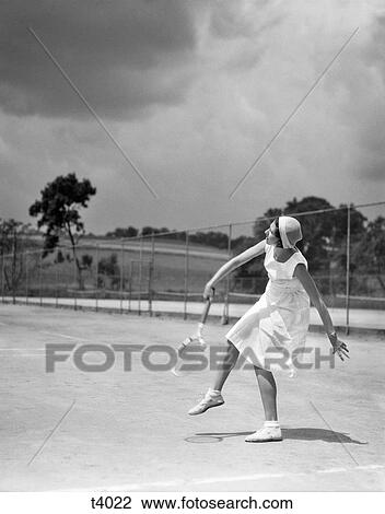 1930s WOMAN PLAYING TENNIS SWINGING RACKET View Large Photo Image Stock Image - 1930s WOMAN PLAYING TENNIS SWINGING RACKET. Fotosearch