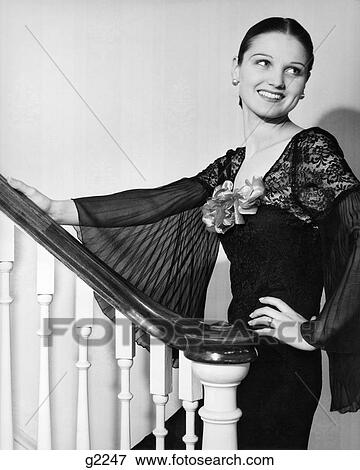 1930S Woman Wearing Spanish Style Dress With Lace & Full Chiffon Sleeves Smiling Standing On Staircase Looking Back View Large Photo Image Stock Photo - 1930S Woman Wearing Spanish Style Dress With Lace & Full Chiffon Sleeves Smiling Standing On Staircase Looking Back. Fotosearch