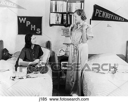 1940S 1930S Two Teen Girls In College Dorm Room Opening Presents Pennants On Wall View Large Photo Image Stock Photography - 1940S 1930S Two Teen Girls In College Dorm Room Opening Presents Pennants On Wall . Fotosearch
