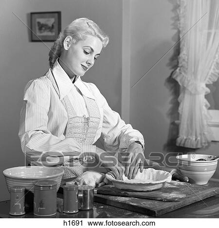 1940s 1950s BLOND WOMAN PREPARING DOUGH MAKING A CRUST TO BAKE A PIE View Large Photo Image Stock Image - 1940s 1950s BLOND WOMAN PREPARING DOUGH MAKING A CRUST TO BAKE A PIE. Fotosearch