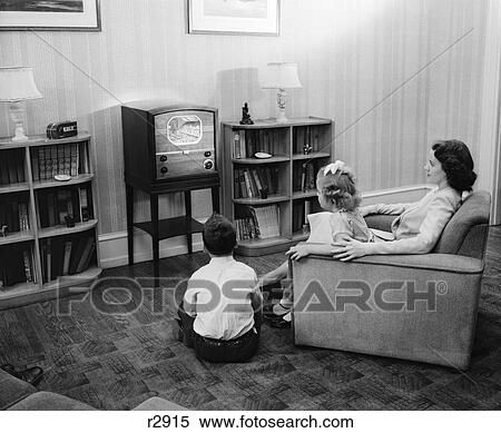 1940S 1950S Mother Boy Girl Watching Television In Family Living Room View Large Photo Image Stock Photography - 1940S 1950S Mother Boy Girl Watching Television In Family Living Room. Fotosearch