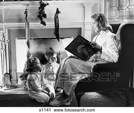 1940s 1950s MOTHER READING CHRISTMAS STORY TO BOY GIRL SITTING BY FIREPLACE HUNG WITH STOCKINGS View Large Photo Image Stock Image - 1940s 1950s MOTHER READING CHRISTMAS STORY TO BOY GIRL SITTING BY FIREPLACE HUNG WITH STOCKINGS. Fotosearch