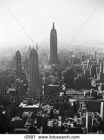 1940s AERIAL VIEW LOOKING SOUTH TO EMPIRE STATE BUILDING FROM TOP ROCKEFELLER CENTER RCA BUILDING MIDTOWN MANHATTAN NYC USA View Large Photo Image Stock Image - 1940s AERIAL VIEW LOOKING SOUTH TO EMPIRE STATE BUILDING FROM TOP ROCKEFELLER CENTER RCA BUILDING MIDTOWN MANHATTAN NYC USA. Fotosearch