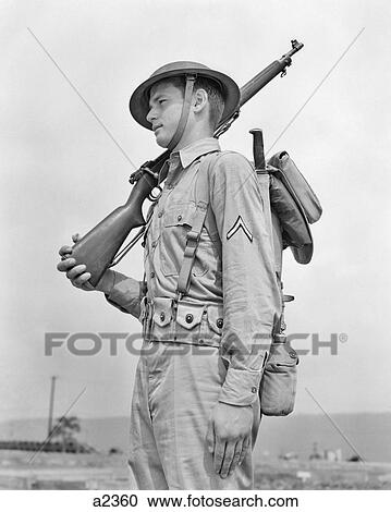1940s AMERICAN SOLDIER RIFLE ON SHOULDER WEARING HELMET KHAKI UNIFORM WITH PRIVATE FIRST CLASS STRIPE ON SLEEVE View Large Photo Image Stock Image - 1940s AMERICAN SOLDIER RIFLE ON SHOULDER WEARING HELMET KHAKI UNIFORM WITH PRIVATE FIRST CLASS STRIPE ON SLEEVE. Fotosearch