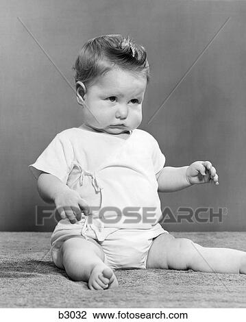 1940s BABY SITTING CHIN DOWN FROWNING View Large Photo Image Stock Image - 1940s BABY SITTING CHIN DOWN FROWNING. Fotosearch