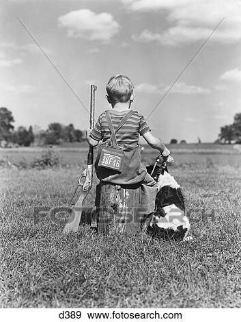 1940S Back View Of Boy Wearing Hunting Permit Holding Bb Gun Sitting On Tree Stump Next To Springer Spaniel Dog View Large Photo Image Stock Photo - 1940S Back View Of Boy Wearing Hunting Permit Holding Bb Gun Sitting On Tree Stump Next To Springer Spaniel Dog . Fotosearch