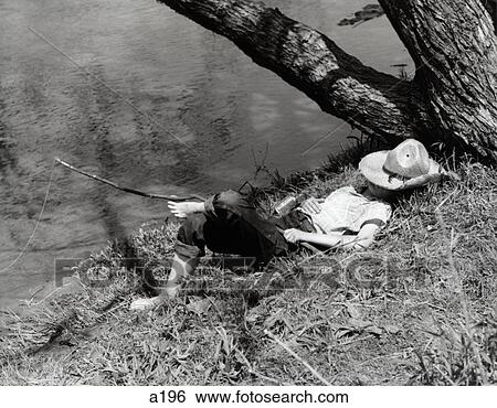 1940S Barefoot Boy Sleeping Under Tree Straw Hat Covering Face Fishing Line In Stream View Large Photo Image Stock Photograph - 1940S Barefoot Boy Sleeping Under Tree Straw Hat Covering Face Fishing Line In Stream . Fotosearch