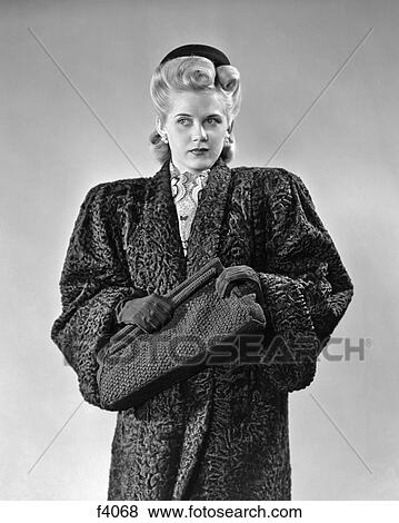 1940s BLOND WOMAN LOOKING OFF TO SIDE WEARING PERSIAN LAMB COAT CLUTCHING HAND BAG FASHION NOIR View Large Photo Image Stock Photo - 1940s BLOND WOMAN LOOKING OFF TO SIDE WEARING PERSIAN LAMB COAT CLUTCHING HAND BAG FASHION NOIR. Fotosearch