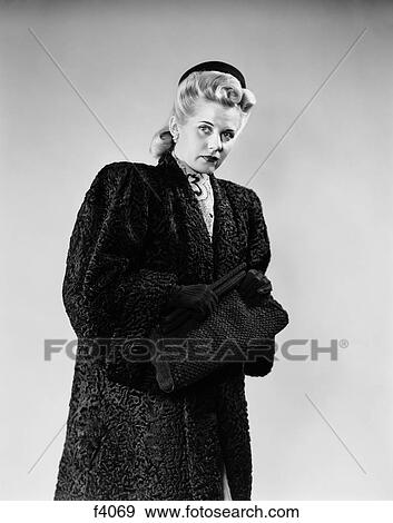 1940s BLOND WOMAN WEARING LAMBS WOOL COAT UNCERTAIN SUSPICIOUS LOOK FILM NOIR FEEL View Large Photo Image Stock Photo - 1940s BLOND WOMAN WEARING LAMBS WOOL COAT UNCERTAIN SUSPICIOUS LOOK FILM NOIR FEEL. Fotosearch