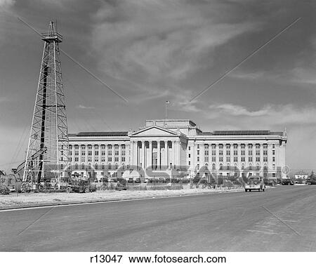 Stock Photo - 1940s CAPITOL BUILDING WITH OIL DERRICK IN FOREGROUND OKLAHOMA CITY OKLAHOMA USA. Fotosearch