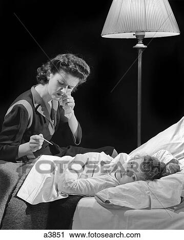 1940s CONCERNED WORRIED WOMAN MOTHER CHECKING THERMOMETER TAKING TEMPERATURE OF ILL GIRL DAUGHTER LAYING IN BED View Large Photo Image Stock Image - 1940s CONCERNED WORRIED WOMAN MOTHER CHECKING THERMOMETER TAKING TEMPERATURE OF ILL GIRL DAUGHTER LAYING IN BED. Fotosearch