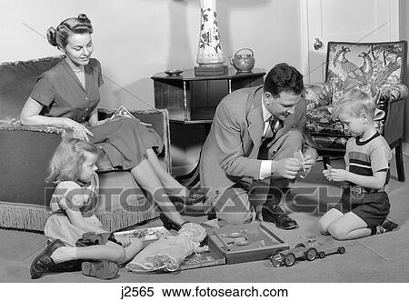 1940S Family Father Mother Daughter Son Together In Living Room With Toy Erector Set View Large Photo Image Stock Photography - 1940S Family Father Mother Daughter Son Together In Living Room With Toy Erector Set. Fotosearch