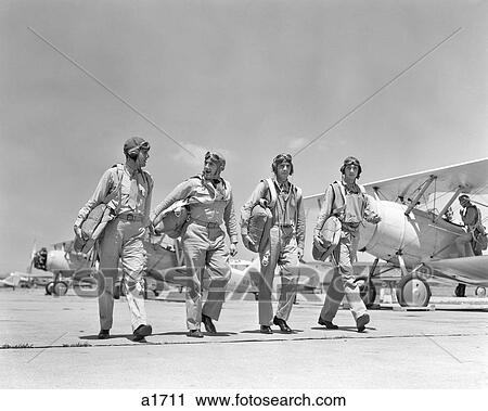 1940S FOUR U. S. NAVY PILOTS WALKING TOGETHER ON TARMAC RETURNING FROM AIR MANEUVERS AT THE PHILADELPHIA NAVY YARD PA USA View Large Photo Image Stock Image - 1940S FOUR U. S. NAVY PILOTS WALKING TOGETHER ON TARMAC RETURNING FROM AIR MANEUVERS AT THE PHILADELPHIA NAVY YARD PA USA. Fotosearch