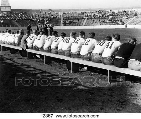 1940S High School Or Collegiate Football Teams From Behind All Sitting On Sideline Benches View Large Photo Image Stock Photo - 1940S High School Or Collegiate Football Teams From Behind All Sitting On Sideline Benches. Fotosearch