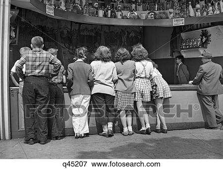 Stock Photo - 1940S Line Of Anonymous Children Lining Counter At Amusement Park Game Booth Palisades Park Fort Lee New Jersey Usa . Fotosearch