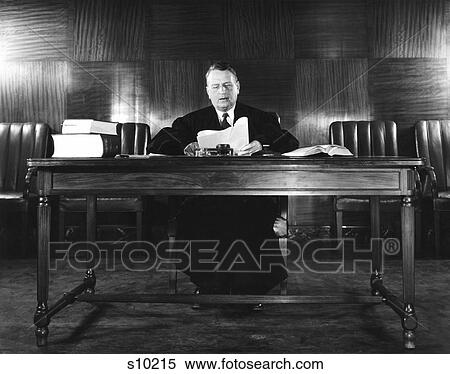 1940S Man Judge Reading Papers Wearing Robe Seated At Desk View Large Photo Image Stock Photography - 1940S Man Judge Reading Papers Wearing Robe Seated At Desk . Fotosearch