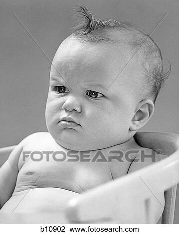 1940s PORTRAIT BABY FROWNING SCOWLING SITTING IN CHAIR View Large Photo Image Stock Image - 1940s PORTRAIT BABY FROWNING SCOWLING SITTING IN CHAIR. Fotosearch