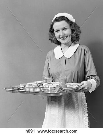 1940s WAITRESS MAID CARRYING TRAY FOOD SERVICE SMILING LOOKING AT CAMERA View Large Photo Image Stock Image - 1940s WAITRESS MAID CARRYING TRAY FOOD SERVICE SMILING LOOKING AT CAMERA. Fotosearch