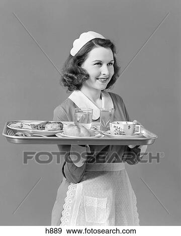 1940s WAITRESS MAID CARRYING TRAY WITH FOOD SERVICE View Large Photo Image Stock Photo - 1940s WAITRESS MAID CARRYING TRAY WITH FOOD SERVICE. Fotosearch