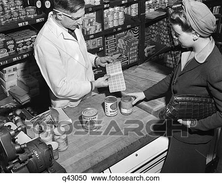 1940S Woman Purchasing Can Goods Counting Ration Coupons Stamp Book In Neighborhood Grocery New York City Usa View Large Photo Image Stock Image - 1940S Woman Purchasing Can Goods Counting Ration Coupons Stamp Book In Neighborhood Grocery New York City Usa. Fotosearch