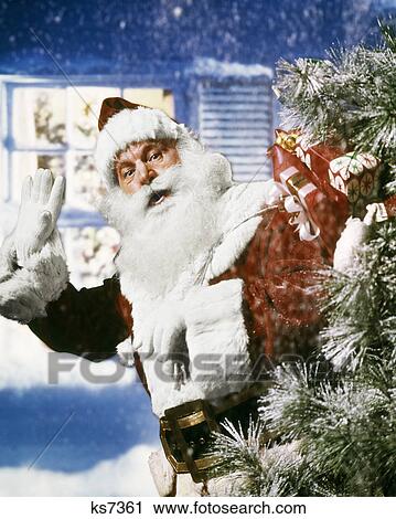 1950s 1960s 1970s SANTA CLAUS WITH PACK OF PRESENTS TOYS WAVING IN SNOW IN FRONT OF HOUSE OUTDOOR CHRISTMAS View Large Photo Image Stock Image - 1950s 1960s 1970s SANTA CLAUS WITH PACK OF PRESENTS TOYS WAVING IN SNOW IN FRONT OF HOUSE OUTDOOR CHRISTMAS. Fotosearch