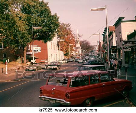 1950s 1960s AMERICANA SMALL TOWN MAIN STREET SCENE CARS PARKED SHOPS STOREFRONTS View Large Photo Image Stock Photography - 1950s 1960s AMERICANA SMALL TOWN MAIN STREET SCENE CARS PARKED SHOPS STOREFRONTS. Fotosearch