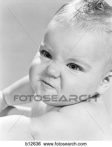Stock Photograph - 1950s 1960s BABY GIRL LOOKING ANGRY MAD MEAN. Fotosearch